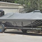 Boat parked on the trailer with a cover