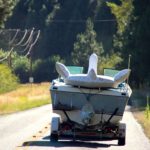 Boat being towed on a trailer with an inflatable water toy