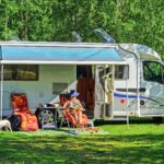 A lady lounging outside while camping at an RV campground