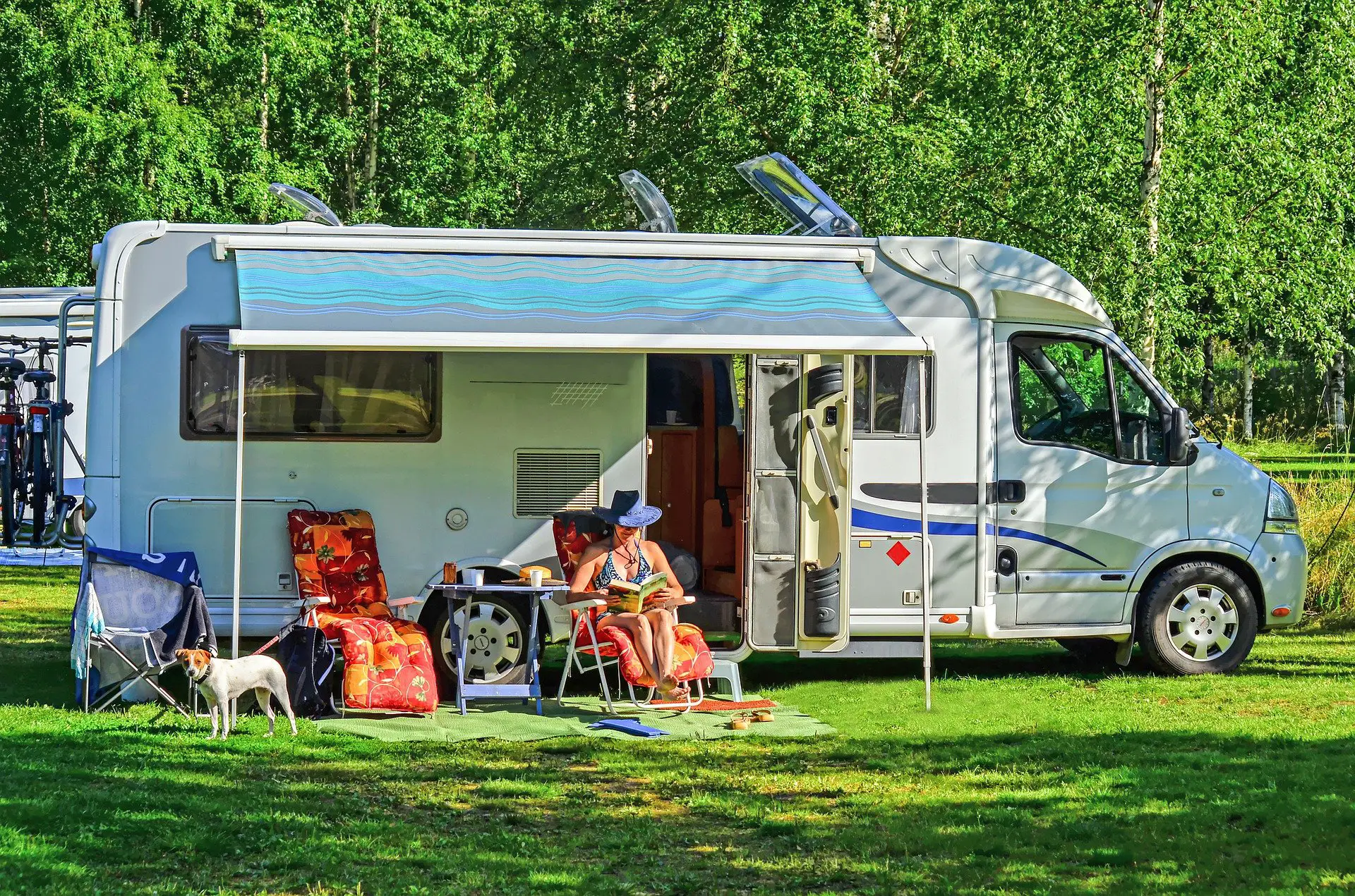 A lady lounging outside while camping at an RV campground
