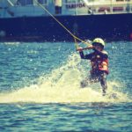 Kid having fun boating and participating in watersports