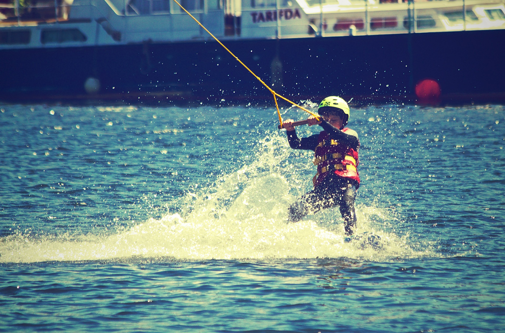 Kid having fun boating and participating in watersports