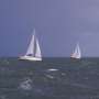 Sail boats experiencing rough sea conditions