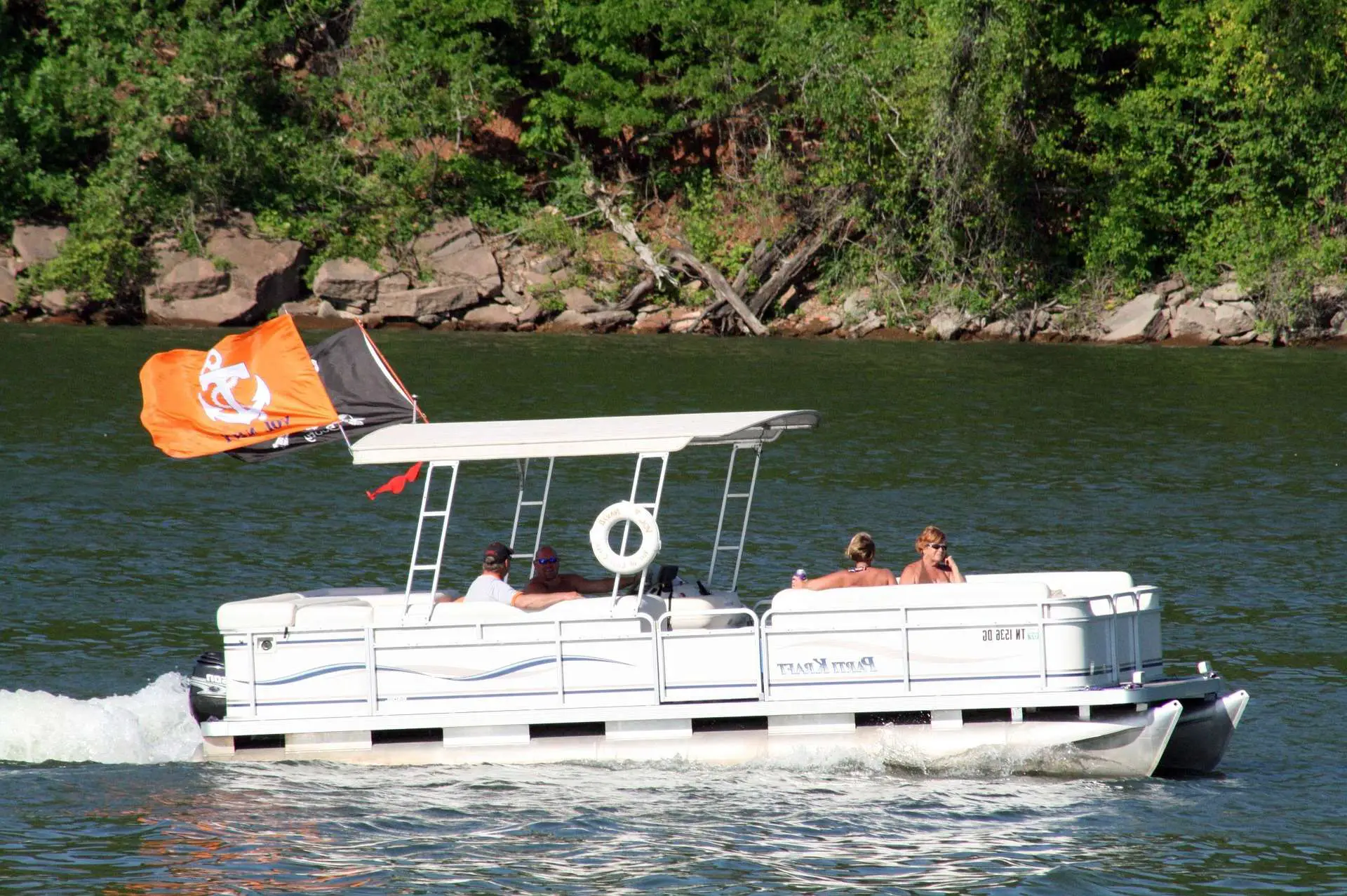 A pontoon with a family on a lake