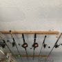 A fishing rod rack mounted on a garage ceiling