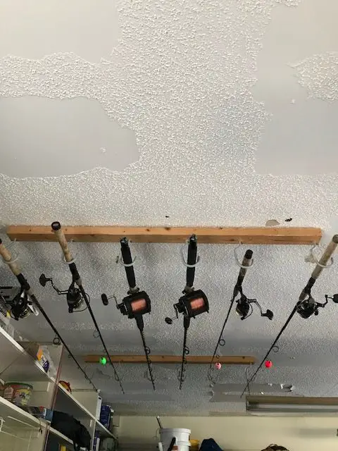 A fishing rod rack mounted on a garage ceiling