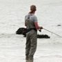 Person wading in the water with fishing pants