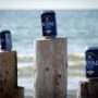 Beers lined up along beach pilings