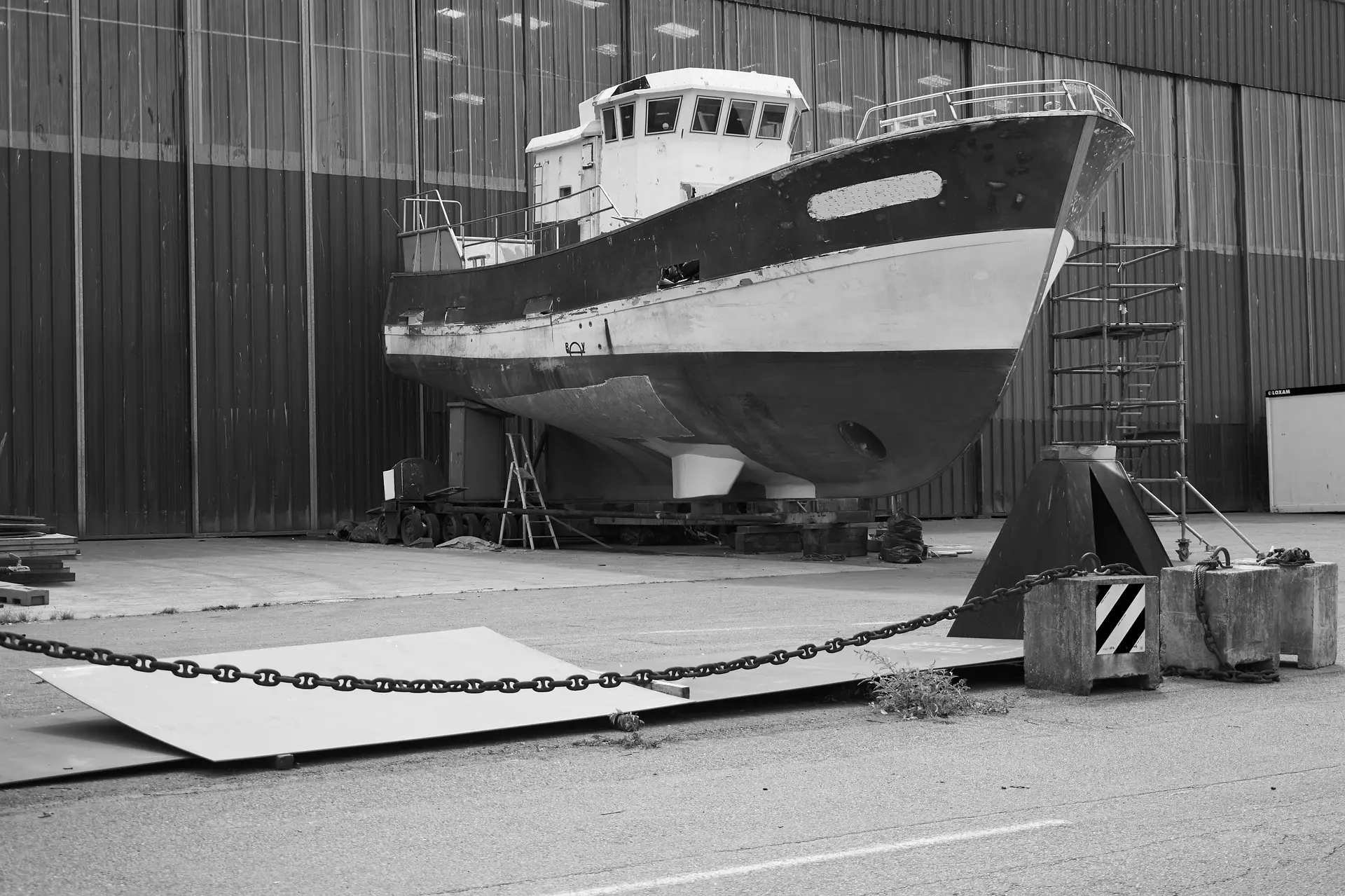 A boat hauled out of the water at a shipyard