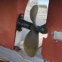 A boat zinc or anode mounted on the rudder