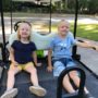 Kids sitting on a golf cart heading to Publix